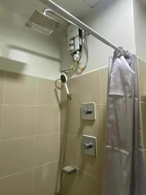 a shower in a bathroom with a shower curtain at Staycation Delight by R2CK in Manila