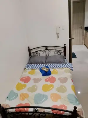 a bed with a colorful comforter on top of it at Jaina Staycation in Manila