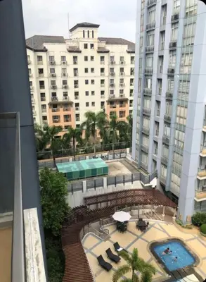 a view from the balcony of a building with a pool at Sun Property in Manila