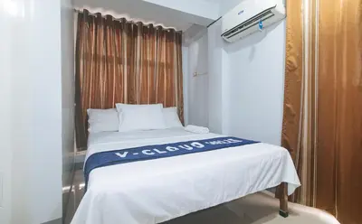 a bed in a small room with a window at VCloud Hills Boarding House Near NAIA Terminal in Manila