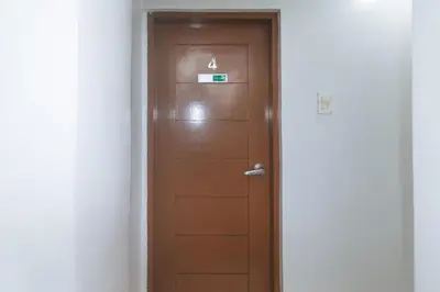 a wooden door with a number four sign on it at VCloud Hills Boarding House Near NAIA Terminal in Manila