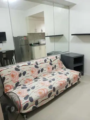 a couch in a room with flowers on it at Tower F Sea Residence in Manila