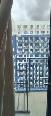a view of a large building from a window at Tower F Sea Residence in Manila