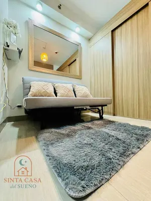 a room with a bed and a mirror and a rug at Sinta Casa del Sueno MOA Stay with Pool and Wi-fi in Manila