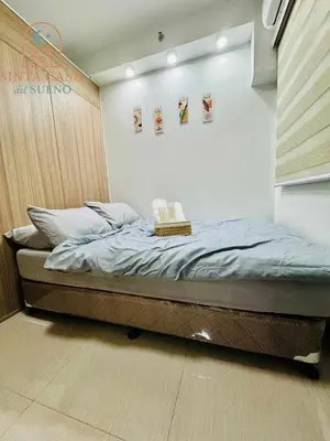 a bedroom with a bed with two books on it at Sinta Casa del Sueno MOA Stay with Pool and Wi-fi in Manila