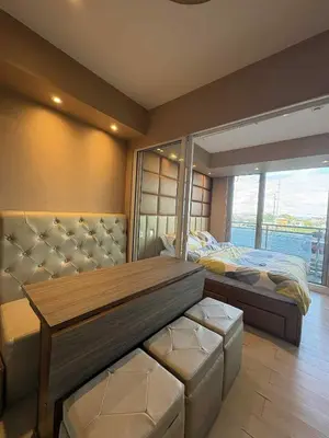 a bedroom with a bed and a large window at La Casa 543 in Manila