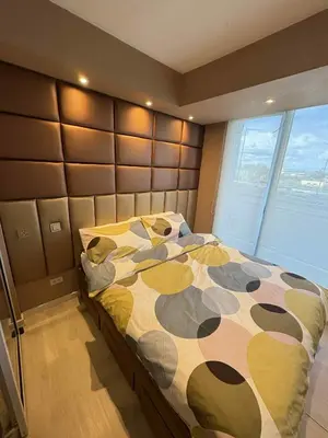 a bedroom with a bed and a large window at La Casa 543 in Manila