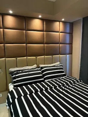 a bedroom with a large bed with black and white stripes at La Casa 543 in Manila