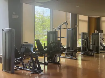 a gym with chairs and treadmills in a room at Levi & Moon's Manila Bay in Manila