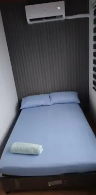 a bed with a pillow sitting on top of it at Auntie's in Tanza