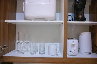 a shelf with wine glasses and a blender on it at E-Studio,Best Sunset Pool,Luxury,Hotel Style in Manila
