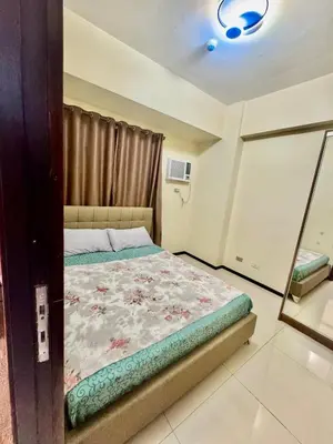 a bedroom with a bed and a mirror at Levi & Moon Relax and Chill in Manila