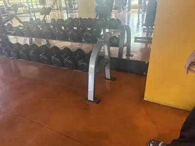 a rack of dumbbells in a gym at Levi & Moon Relax and Chill in Manila
