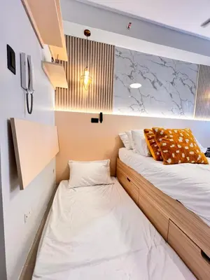 two beds in a small room next to each other at Condo Living at Shore with Parking in Manila