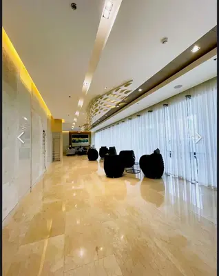 a lobby with chairs sitting in the middle of a room at SkyShore Suites in Manila