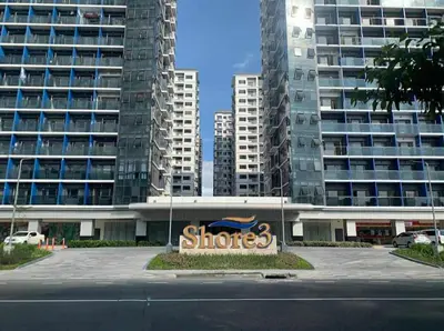 a stores sign in front of some tall buildings at SkyShore Suites in Manila