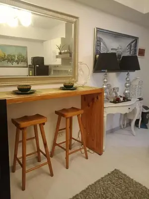 a table with two stools and a mirror in a room at Azure Urban Resort Residences - St Tropez Tower in Manila