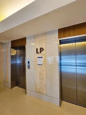 an elevator lobby with two elevators in a building at Maison dela Mer SMDC Breeze Residences Pasay in Manila