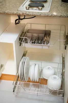 a dish drying rack in a kitchen with dishes at Luxurious Maison at 81 Newport near Terminal 3 Airport in Manila