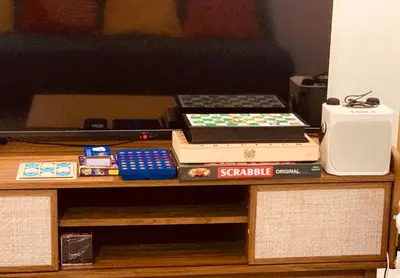 a table topped with books and a computer on top at Cozy 1BR Staycation at Satori Residences, Pasig in Manila
