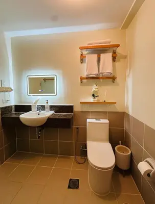 a bathroom with a toilet and a sink at Cozy 1BR Staycation at Satori Residences, Pasig in Manila
