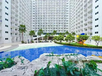 a large swimming pool in the middle of a building at SHORE 2 TOWER 2 7th floor Near MOA Easy Vacation Shopping Center in Manila