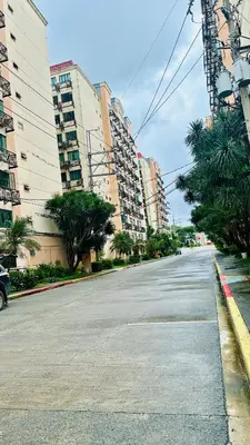 an empty street in a city with tall buildings at Terravive in Manila