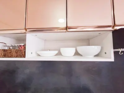 a shelf with three white bowls on it at Vibrant Spacious Condo near SM East NU Medical City in Manila