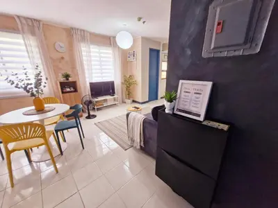 a living room with a couch and a table at Vibrant Spacious Condo near SM East NU Medical City in Manila