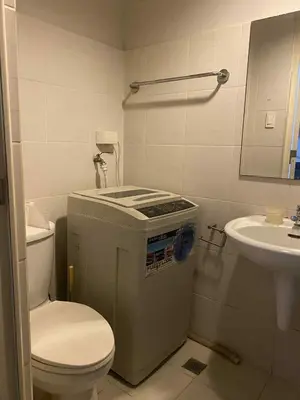 a small bathroom with a toilet and a sink at Sea Residences Tower F in Manila