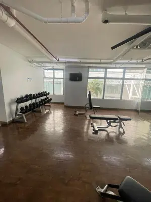 an empty room with a gym with chairs and a screen at Antel Spa Residences 10E in Manila