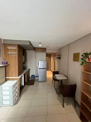 a kitchen with a refrigerator and a table at Antel Spa Residences 10E in Manila
