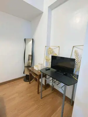 a room with a table with a laptop on it at Isabelle Garden Hotel & Suites in Manila