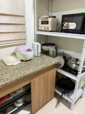 a kitchen with a counter with some dishes on it at fairlane residences in Manila