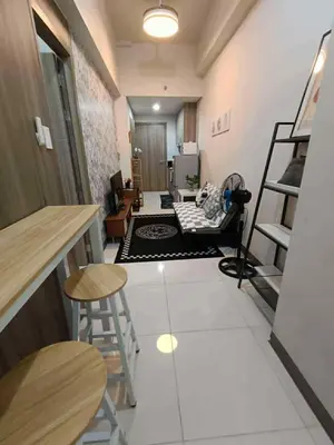 a living room with a staircase and a room with chairs at Modern Comfort in Pasay with Pool in Manila