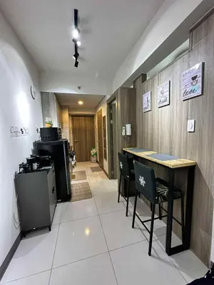 a restaurant with a table and chairs in a room at Modern Comfort in Pasay with Pool in Manila