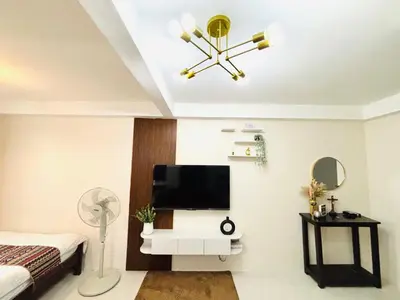 a bedroom with a bed and a television on a wall at Dainty Den LF508 - Comfy & Chic Home beside Enchanted Kingdom in Santa Rosa