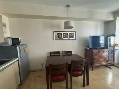 a kitchen with a table and chairs in a room at SOHO Central Condotel in Manila