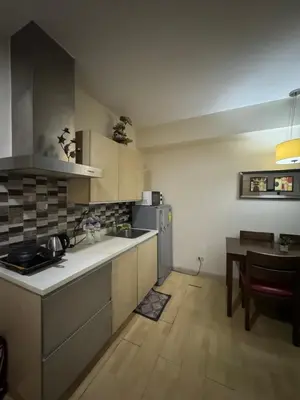 a kitchen with a counter and a table in it at SOHO Central Condotel in Manila