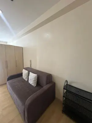 a living room with a couch in a room at SOHO Central Condotel in Manila