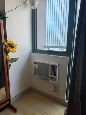 a room with a air conditioner in a window at SOHO Central Condotel in Manila