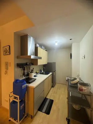 a kitchen with a counter and a refrigerator at SOHO Central Condotel in Manila