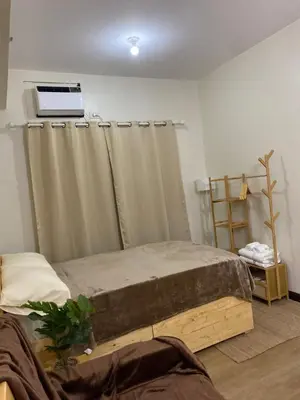 a bedroom with a bed with curtains and a window at The Stayhaus by Dan & Steph in Manila