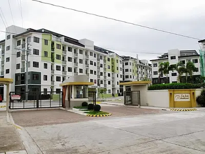 a large apartment building with a gate in front of it at Dainty Den Renovation in Macabling
