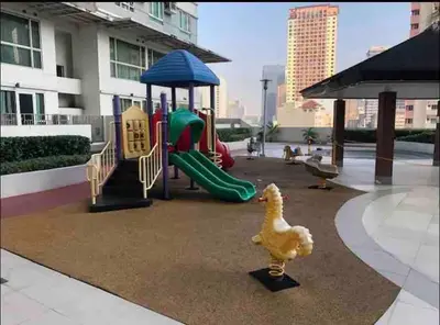 a chicken is standing next to a playground at Affordable Nordic Style Condo in Makati in Manila
