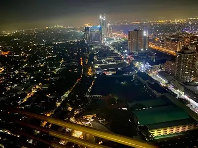 a view of a city at night at Affordable Nordic Style Condo in Makati in Manila