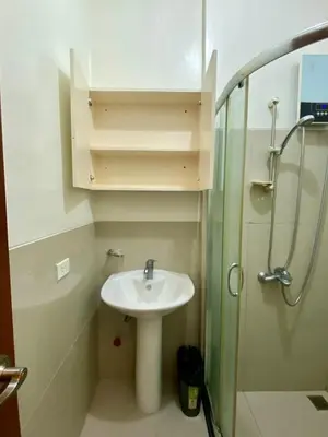 a bathroom with a sink and a shower at Affordable Nordic Style Condo in Makati in Manila