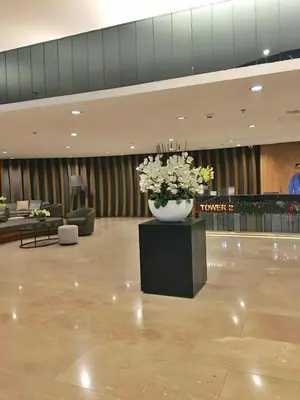 a lobby with a large vase with flowers in it at Cloud 1979 at Shore 2 Tower 2 in Manila