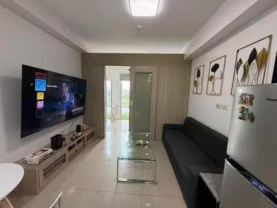 a living room with a couch and a flat screen tv at Shore Residences in Manila
