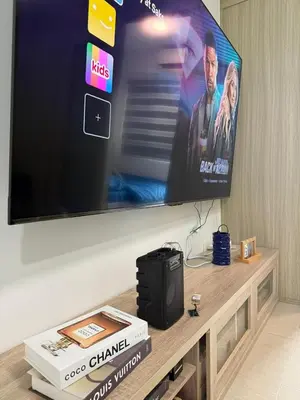 a flat screen tv sitting on top of a table at Shore Residences in Manila